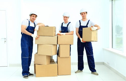 Furniture and boxes being carried from a Docklands flat by a moving team