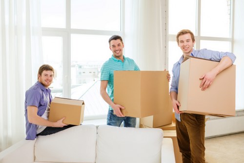 Safety-focused moving crew assessing risks and protecting fragile items