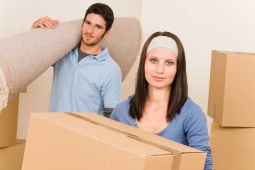 Professional movers handling furniture in a Docklands apartment building